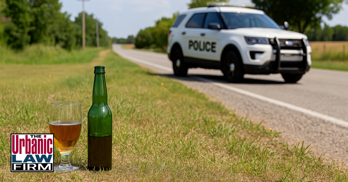 Police SUV parked on a rural roadside with a beer bottle and glass placed on the grass during daytime