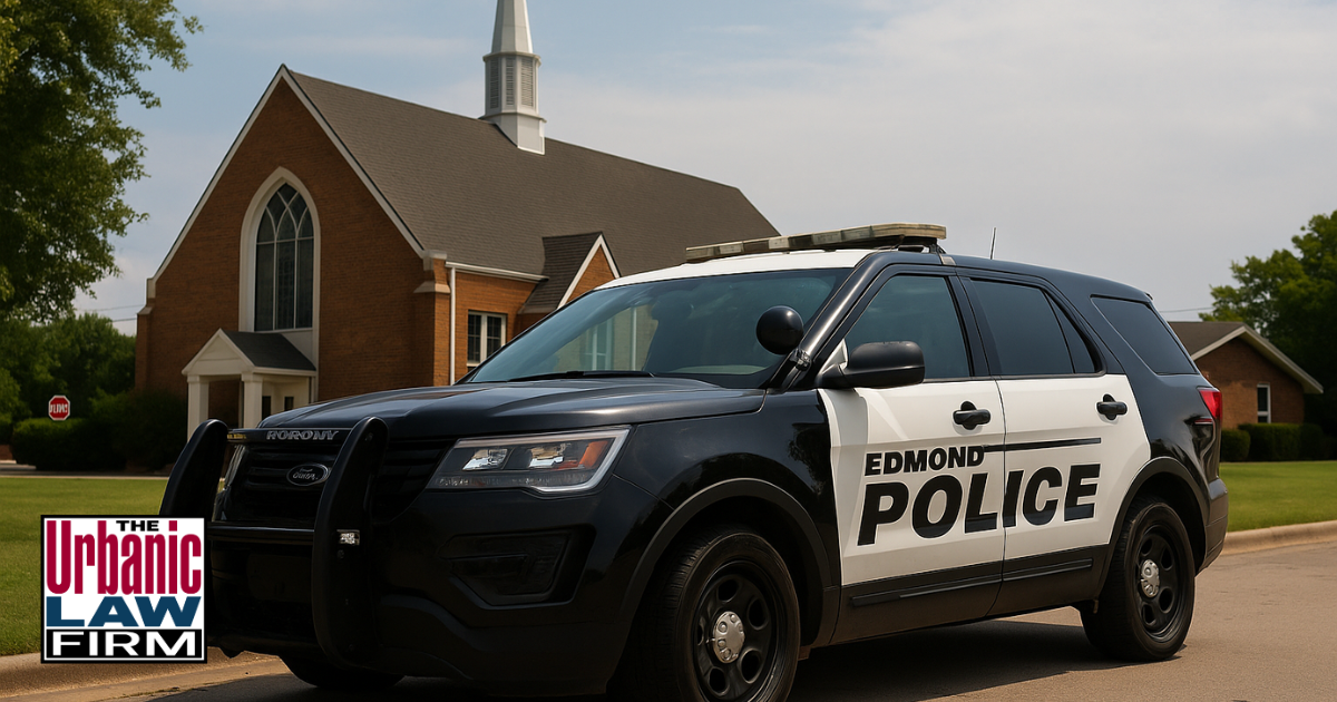 Daytime image of an Edmond police SUV parked in front of a red brick Oklahoma church, representing a trespassing and sexual battery arrest scene.