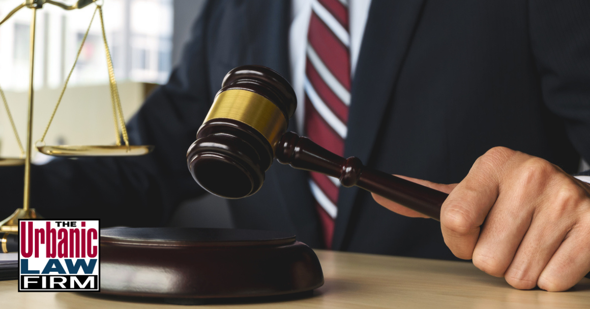 Daytime courtroom-style photo of an Oklahoma judge holding a wooden gavel over the bench, symbolizing serious felony charges and strong Oklahoma obscene and threatening communication criminal defense representation by The Urbanic Law Firm.
