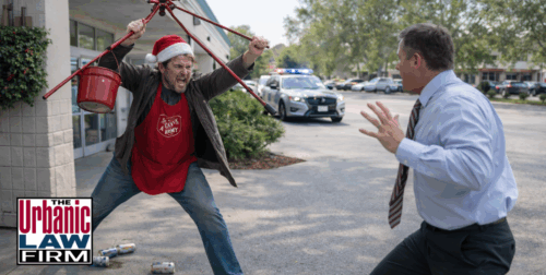 Daytime photo-style image of a Salvation Army bell ringer in a Santa hat lifting a red donation tripod toward a retreating store manager outside a grocery store while police cars approach in the background, illustrating high-stakes Oklahoma criminal defense representation by The Urbanic Law Firm in assault and resisting arrest cases.