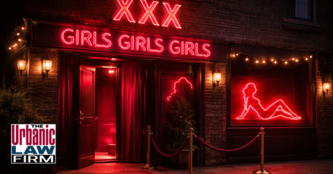 Photograph of a dimly lit brick building with a discreet entrance suggesting a brothel on an Oklahoma city street at night, symbolizing Oklahoma prostitution and pimping criminal defense representation by The Urbanic Law Firm.