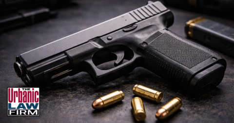 Daytime close-up photograph of a black handgun on a clean surface, symbolizing Self-Defense Act firearm administrative offenses in Oklahoma and highlighting Oklahoma criminal defense representation by The Urbanic Law Firm.