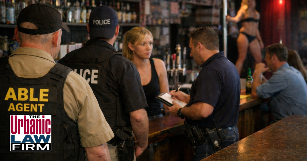 Daytime bar inspection scene showing officers and staff during an Oklahoma alcohol service crimes investigation, highlighting Oklahoma criminal defense by The Urbanic Law Firm.