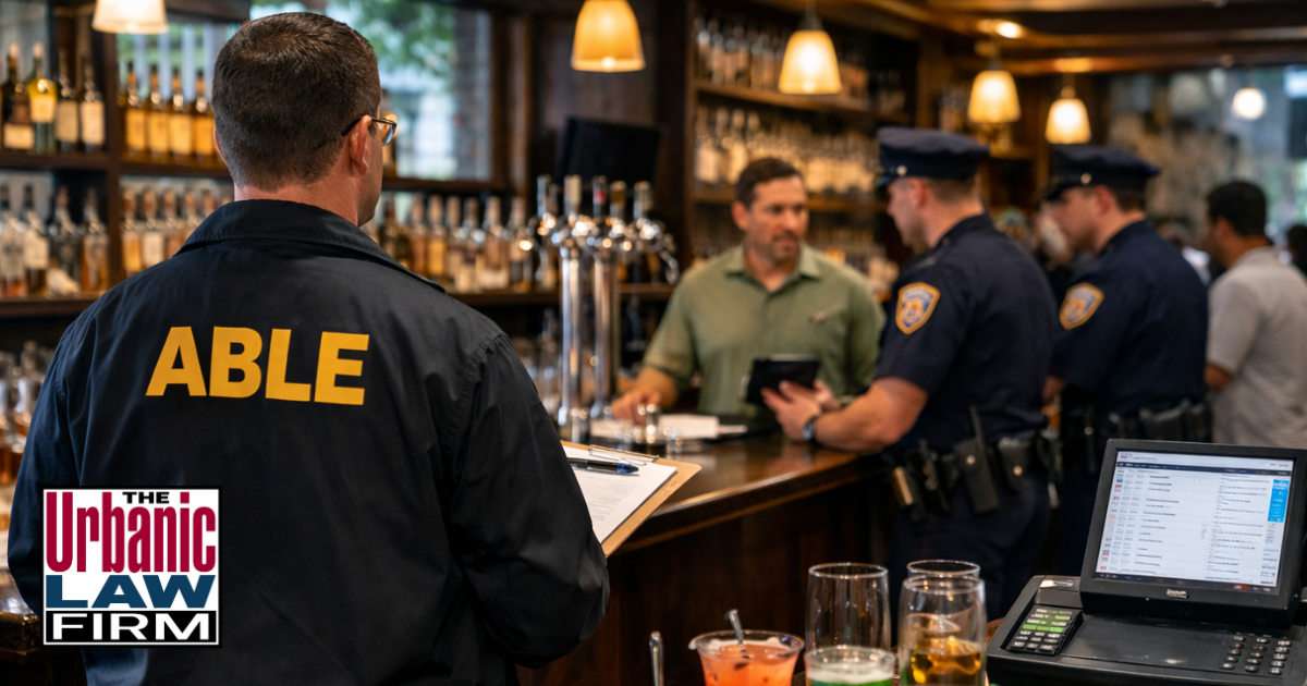 Daytime photograph-style image inside an Oklahoma bar showing a criminal-defense attorney from The Urbanic Law Firm observing a bartender and patron during an alcohol service interaction, visually representing Oklahoma alcohol service crimes investigations and strong Oklahoma criminal-defense representation by The Urbanic Law Firm.
