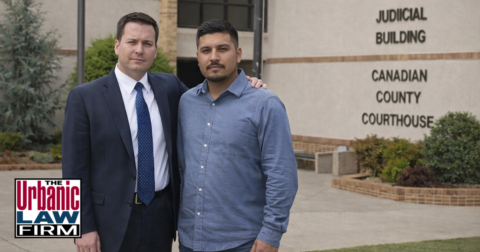 Canadian County criminal defense attorney from The Urbanic Law Firm standing with a client outside the Canadian County Courthouse in Oklahoma, symbolizing dedicated criminal defense representation and personalized legal guidance.