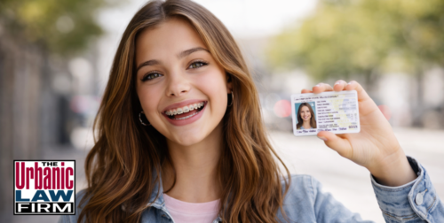 Teen driver smiling and holding up her driver’s license, representing Oklahoma save your license help and Oklahoma criminal defense by The Urbanic Law Firm.