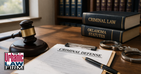 Generic criminal defense office scene with case file, law books, handcuffs, and gavel, representing verbal abuse caretaker Oklahoma criminal defense by The Urbanic Law Firm.