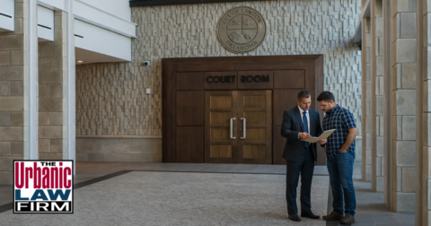 Lawton Oklahoma Municipal Court criminal defense lawyers with The Urbanic Law Firm meeting a client inside the courthouse hallway before court.