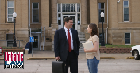 Attorney and client standing outside the Logan County courthouse in Oklahoma, illustrating criminal defense representation by The Urbanic Law Firm in a real-world case setting.