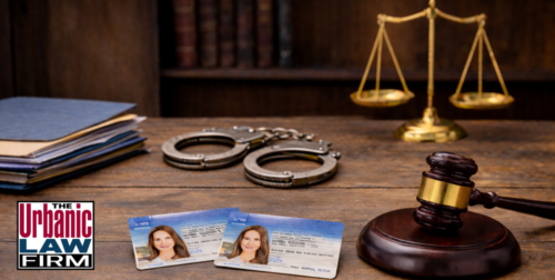 Oklahoma age of consent criminal defense image showing ID cards, handcuffs, folders, and a gavel on a table for The Urbanic Law Firm