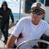 Oklahoma boat stabbing scene showing a captain on a boat on an Oklahoma lake as a man approaches with a knife, illustrating Oklahoma criminal defense by The Urbanic Law Firm.