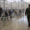 Immigrants held in an ICE detention center illustrating Oklahoma immigration consequences of criminal charges and criminal defense concerns handled by The Urbanic Law Firm.