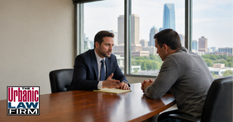 Oklahoma sexual battery criminal defense consultation at The Urbanic Law Firm showing an attorney meeting with a concerned client in a professional daytime office setting.