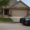 Police SUV outside an Oklahoma home representing Oklahoma domestic abuse changes and criminal defense by The Urbanic Law Firm.