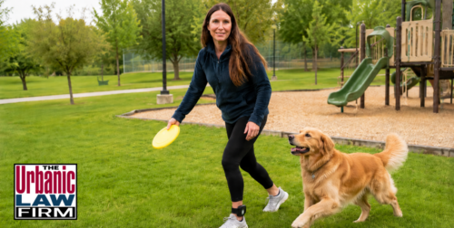 Woman on Oklahoma SB 137 electronic monitoring playing with a golden retriever in a park, illustrating Oklahoma criminal defense issues analyzed by The Urbanic Law Firm.
