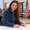 Illustration of a smiling woman filling out a ballot for The Urbanic Law Firm’s criminal defense analysis of Sara Polston’s Oklahoma illegal voting case.